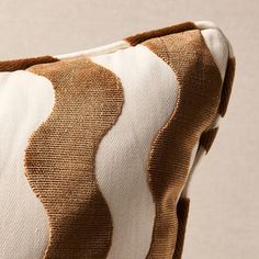 a brown and white pillow sitting on top of a table