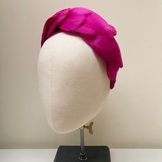 "FABRIC This Women's fascinator headband is carefully hand made. The headband has been covered in a complementary crepe fabric and each feather has been attached within the seams of the fabric headband for a flawless finish. The head crown is light, soft and super comfortable and boasts a quality finish. FIT and SIZE A flexible base band to fit all head sizes.  PACKAGING Each headband is wrapped in pretty acid free tissue paper, sealed with an Evierosemade brand sticker and shipped in an eco-friendly cardboard gift box to protect while in transit. If you are purchasing as a gift, please select \"This order is a gift\" (the item price will not be included in the gift box). If you would also like to add a personalised message to the recipient, please enter your message in the box marked \"Ad Pink Structured Crown Fascinator For Wedding, Pink Structured Crown Headpiece For Wedding, Pink Structured Crown Headpiece For Party, Pink Headband Fascinator For Evening, Pink Evening Fascinator Headband, Pink Pinched Crown Headpiece For Races, Pink Headband For Kentucky Derby, Pink Structured Crown Headpiece For Races, Pink Headband For Royal Ascot