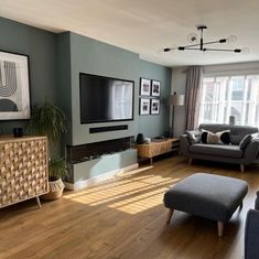 a living room filled with furniture and a flat screen tv