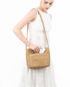 A women's designer crossbody bag for sale online of woven raffia with top zipper closure is super cute for use throughout spring-summer months. The textured weave is intricate with its long strap extending down the sides of the bag body. The mid-size rectangular shape is soft and squishy and feels body friendly. A roomy outer pocket on reverse is for easy access to phone or glasses. Inside: durable cotton canvas lining, sidewall zipper compartment and roomy patch pocket. Dimensions: Front and ba Rectangular Natural Bucket Bag With Intrecciato Weave, Beige Rectangular Straw Bag With Intrecciato Weave, Beige Rectangular Bag With Intrecciato Weave, Natural Rectangular Bag With Intrecciato Weave, Rectangular Natural Bags With Intrecciato Weave, Square Shoulder Bag With Intrecciato Weave For Travel, Natural Rectangular Bags With Intrecciato Weave, Beige Intrecciato Rectangular Bag, Versatile Beige Rectangular Crochet Bag