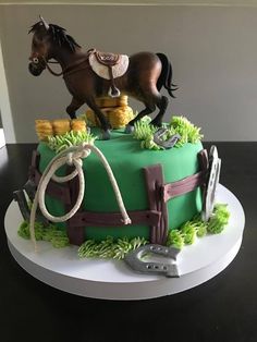 a birthday cake with a horse on the top and green frosting in the middle