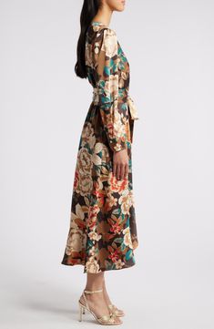 An autumnal floral pattern lends personality to a faux-wrap dress designed with graceful cascading ruffles. 49 1/2" length Hidden back zip with hook-and-eye closure Surplice V-neck Long sleeves Removable tie belt Lined 97% polyester, 3% spandex Dry clean Imported Elegant Floral Print Maxi Wrap Dress, Chic Floral Print Wrap Dress For Fall, Floral Print Maxi Wrap Dress For Party, Formal Floral Print Dress With Surplice Neckline, Floral Print Wrap Dress With Surplice Neckline For Fall, Fall Floral Print Patterned Maxi Dress, Fall Floral Print V-neck Wrap Dress, Fall Floral V-neck Wrap Dress, Floral Print Midi Wrap Dress For Work