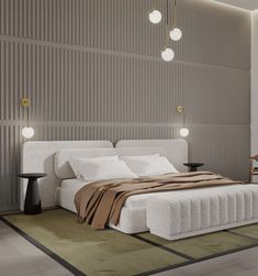 a bedroom with a large bed and lamps on the wall