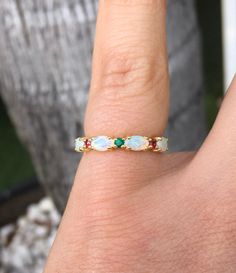 Unique Opal Ring with Alternating Emerald and Ruby. Material: Solid Gold or PLATINUM Finishing: High Polished, Shiny Plating: Rhodium (only if White Gold) Fit: Standard Width: 3.2 mm Height: 3 mm Setting: Prong Stone #1: Natural Opal Shape: Oval Size: 3mm x 5mm Quantity: 5 Opals Stone #2: Natural Emeralds and Natural Rubies Quality: AAA Cut: Round, Diamond Cut Size: 2mm Quantity: 2 Emeralds/ 2 Rubies This band will turn your Engagement Solitaire into a Sophisticated Wedding Set (Bridal Set). It Fine Jewelry Opal Ring With Multi-stone For Anniversary, White Opal Ring With Gemstone Accents As Gift, Wedding Multi-stone Ring With Ethiopian Opal, Anniversary Multi-stone Opal Ring, Wedding Opal Ring With Ethiopian Opal Birthstone, Anniversary Multi-stone Ethiopian Opal Ring, Ethiopian Opal Wedding Ring With Birthstone, Ethiopian Opal Wedding Ring As Birthstone, Anniversary Ethiopian Opal Multi-stone Ring