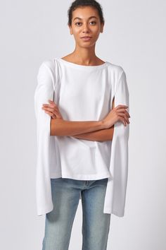 Our Cape Sweatshirt in our Bamboo and Cotton French Terry is the perfect combination of casual and chic. With enough attitude to turn heads, this style pairs well with your favorite jeans or slim trousers.DUE TO POPULAR DEMAND, THIS STYLE WILL REPLENISH MAY 21ST Boatneck shape with facing, cape back detail with longer length, wide hem finish. - 67% Bamboo Rayon, 28% Cotton, 5% Elastin - Made in NYC - Dry Clean or Machine Wash - Our model is 5'9" wearing size S - Chest: 30", Bottom Width: 40, Len Oversized Casual Cape Top, Oversized Cape Top In Casual Style, Elegant Cape Top For Spring, Elegant Spring Cape Top, Spring Casual Cape Tops, Casual Cape Tops For Spring, Casual Cape-style Top, Spring Trousers, Spring Sweatshirt