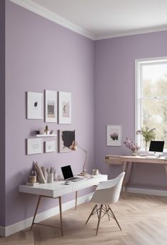 a home office with purple walls and white desks in front of a large window