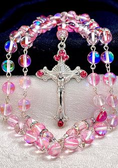 a rosary with pink beads and a cross on it