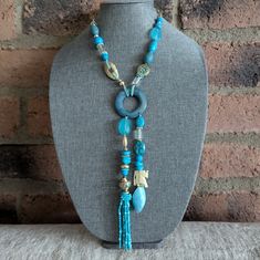 Details: Turquoise Color Elephant Charm Tassel Pendant Gold Tone Hardware Turquoise Beaded Dangle Lariat Necklace, Turquoise Bohemian Tassel Necklace, Turquoise Beaded Necklaces With Tassels For Gift, Adjustable Light Blue Turquoise Necklace In Bohemian Style, Turquoise Necklaces With Dangling Beads For Beach, Bohemian Turquoise Necklaces With Tassels, Adjustable Turquoise Tassel Necklaces, Blue Beaded Tassel Long Necklace, Bohemian Turquoise Tassel Necklace (adjustable)