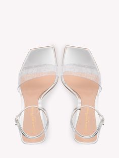 Odyssey silver sandals. They feature Plexi upper, patent leather straps with adjustable Ribbon buckle, graphic design heel and square toe. Heel height: 10,5cm Size nationality: ITA Product number: 33664103 Product code: G3210515PLEPGMSILVER Composition: 50% plexi, 50% calfskin Luxury Silver Heels With Buckle Closure, Modern Sandals With Transparent Straps, Glamorous Open Toe Sandals With Clear Strap, Glamorous Sandals With Clear Strap And Open Toe, Modern Sandals With Transparent Straps And Open Heel, Luxury Patent Leather Sandals With Square Toe, White Open Toe Sandals With Clear Strap, Evening Sandals With Sculpted Heel And Double Strap, Evening Double Strap Sandals With Sculpted Heel