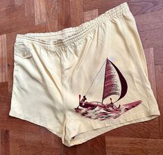 1940s Catalina swimming trunks shorts., styled for the stars in Hollywood! Hand painted sailboat scene on the left side. Still beautiful rayon fabric i a soft yellow color . There is a small coin pocket with button to close which is the only pocket. Interior cotton underwear (with some holes) attached with textured gusset. The elasticized waistband has lost his elasticity but the drawstring to tie closed is still there, i would like to advice to replace the elastic band, there is also a repair a Vintage Bottoms For Beach Season Vacation, Vintage Cotton Beach Bottoms, Vintage Cotton Shorts For The Beach, Summer Swim Trunks With Built-in Shorts And Adjustable Waist, Cotton Swim Trunks With Built-in Shorts For Beachwear, Retro Swim Trunks With Built-in Shorts, Cotton Swim Trunks With Built-in Shorts, Nylon Swim Trunks With Built-in Shorts, Swim Shorts Women