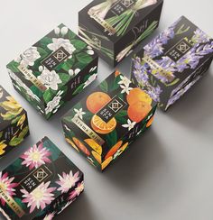 six boxes with flowers and oranges on them