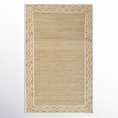 a beige rug with an intricate border on the top and bottom, against a white background