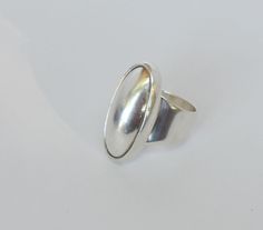 "This unique oval shaped vintage Sterling Silver Ring is large measuring 1 1/4 inches by 3/4 inches. It is artisan made as revealed in its being stamped as \"925\", \"CTI\" and \"Mexico\". It is in very good vintage condition. It is size 6 3/4 but can be readily adjusted without compromising the beauty of its very modernist design. All of our jewelry pieces are sent with \"tracking\" in an attractive gift box and safely mailed in a bubble wrap lined envelope. We ship to most International Locati Vintage Oval Dome Ring As A Gift, Vintage Oval Dome Ring Gift, Classic Silver Oval Dome Ring, Classic Oval Dome Ring Stamped 925, Vintage Oval Dome Ring With Polished Finish, Handmade Oval Dome Ring For Formal Occasions, Vintage Silver Oval Signet Ring, Modern Handmade Oval Signet Ring, Vintage Oval Signet Ring Stamped 925