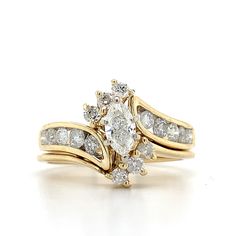 two gold wedding rings with diamonds on each one and an oval shaped diamond in the middle