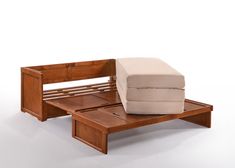 a small wooden bench with a mattress on it's back and footrests