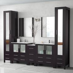 a bathroom with two sinks, mirrors and cabinets in dark brown wood finish on the wall