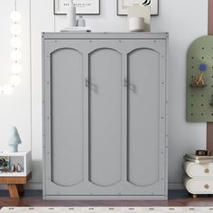 a room with a gray cabinet and pictures on the wall