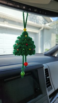 a christmas tree hanging from the dashboard of a car