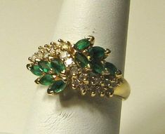 Excellent condition. Stamped 14K and BH.  All natural stones. Marquise cut emeralds measure approx. 3 x 2.5mm.  Round full cut diamonds measure approx. 1.5mm each, approx. 0.01 carat each. Ring weighs 4.9 grams.  Size 7 and easily sizable. Green Emerald Cluster Ring With Diamond Accents, Cluster Emerald Ring, Bypass Ring, Ring Ideas, Pretty Rings, Emerald Jewelry, Marquise Cut, Rings Statement, Round Diamond