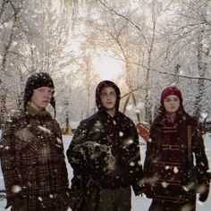 three people are standing in the snow