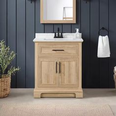 a white sink sitting under a mirror next to a wooden cabinet