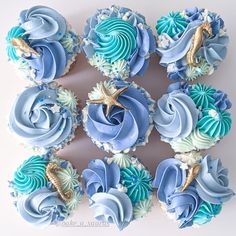 cupcakes decorated with blue and white frosting, seahorse on the top