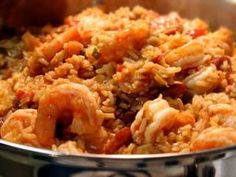 shrimp and rice in a pan on the stove