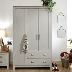 a white armoire sitting next to a wooden floor