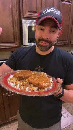 a man holding a plate with food on it