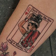 a woman's leg with a playing card tattoo on her left arm and the words don't stop me now