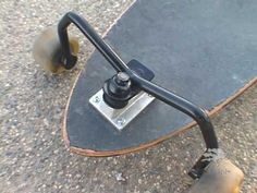 a skateboard is sitting on the ground with its wheels still attached to it's board