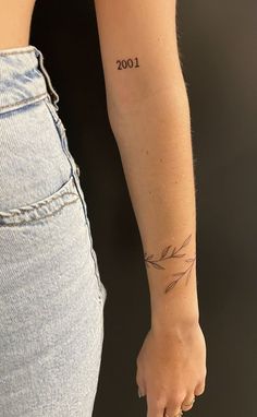 a woman's arm with a small tattoo on the left side of her body