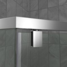 the corner of a shower stall is shown in grey tile and stainless steel trims