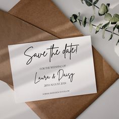 save the date cards on top of brown envelopes