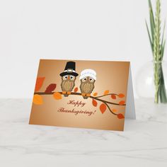 two owls are sitting on a branch with an orange background and the words happy thanksgiving