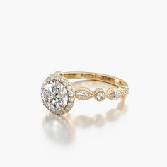 a rose gold engagement ring set with an oval diamond center surrounded by small round diamonds