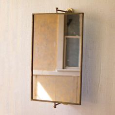 a mirror mounted to the side of a wall