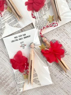 three small wooden pegs with red flowers on them sitting next to an envelope that says make your own catholic angel ornament