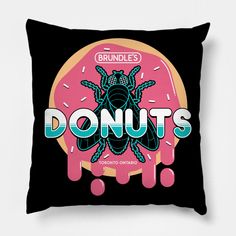 a black pillow with the words donuts on it and an image of a pink donut