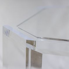 an acrylic table with clear plastic covering on it's sides and silver legs