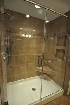 a walk in shower sitting next to a bath tub