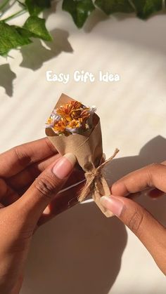 someone is holding a small flower in their left hand and the words easy gift idea written on it