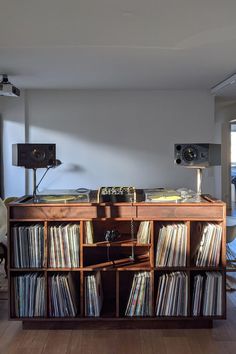 an old record player sits on top of a wooden shelf