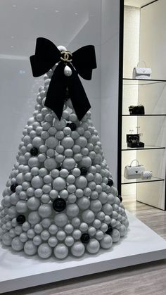 a christmas tree made out of balls with a black bow