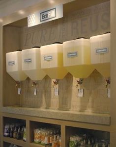 a display case filled with lots of different types of juices and drinks in plastic containers