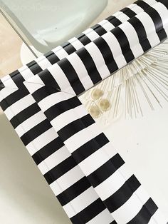 a black and white striped umbrella sitting on top of a table