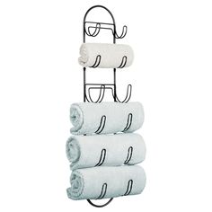 three towels are stacked on top of each other in front of a rack with two towel holders