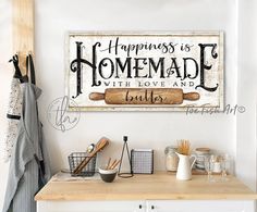 a wooden sign that says happiness is homemade with love and builder on the wall above it