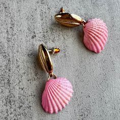 Channel your inner beach babe with Enchanted at Sea Pink Seashell Dangle Coastal Earrings. These playful earrings exude calm and charm, adding a pop of coastal energy to any outfit. Perfect for those who love all things beachy. Pink Shell Ocean-inspired Jewelry, Beachy Shell Dangle Earrings, Bohemian Pink Jewelry For Beach Party, Pink Shell-shaped Summer Jewelry, Beach Season Shell Earrings Gift, Pink Shell-shaped Jewelry For Summer, Beach Season Gift Shell Earrings, Shell Earrings For Beach Season Gift, Pink Shell Jewelry For Summer