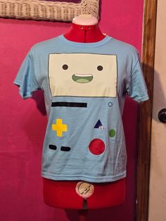 A custom made t-shirt of BMO from Adventure Time. Sizing is in US adult letter from Small to 2XL Unisex Crew Neck T-shirt For Fan Merchandise, Adventure Time Clothes, Adventure Time Shirt, Custom Made T Shirts, White Plains, Adventure Time, Custom Made, Adult Outfits, Tops & Tees